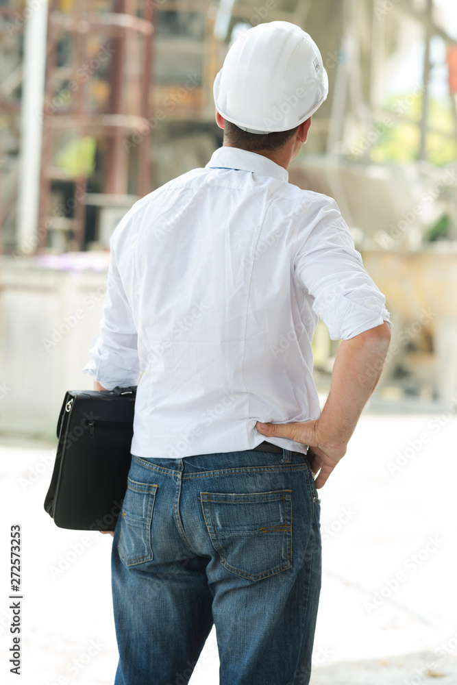 back view of successful manager looking the construction site