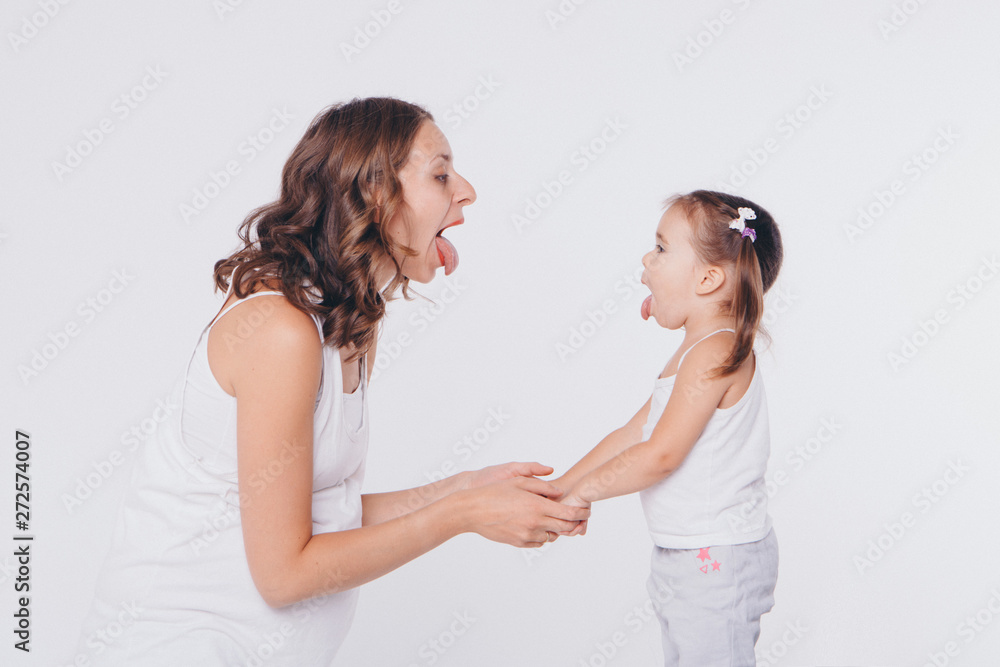 mother and daughter show each other language. Health and hygiene in women on a white background mother and daughter show each other language. Health and hygiene in women on a white background