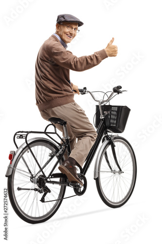 Cheerful elderly man on a bicycle giving thumbs up