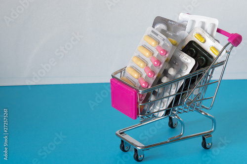 Food basket filled with drugs on a blue background