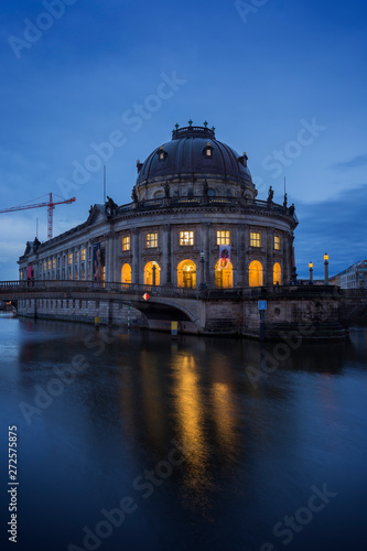 Beautiful view of the Bode Museum and its reflections on the Spree River in Berlin, Germany, at dusk.