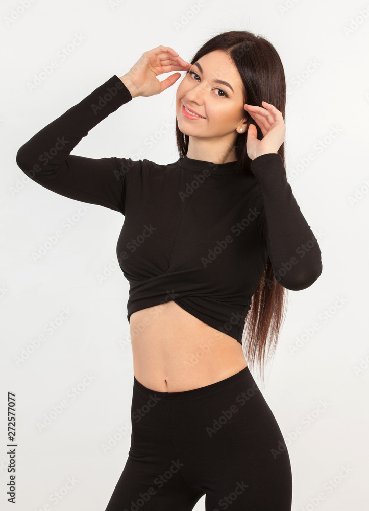 Pretty woman in black suit. Close up portrait of sporty beautiful female body. Tanned brunette portrait. Healthy lifestyle, dieting, fitness, weight loss Pretty woman in black suit. Close up portrait of sporty beautiful female body. Tanned brunette portrait. Healthy lifestyle, dieting, fitness, weight loss