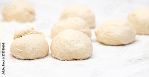 Dough pieces on the table in the kitchen