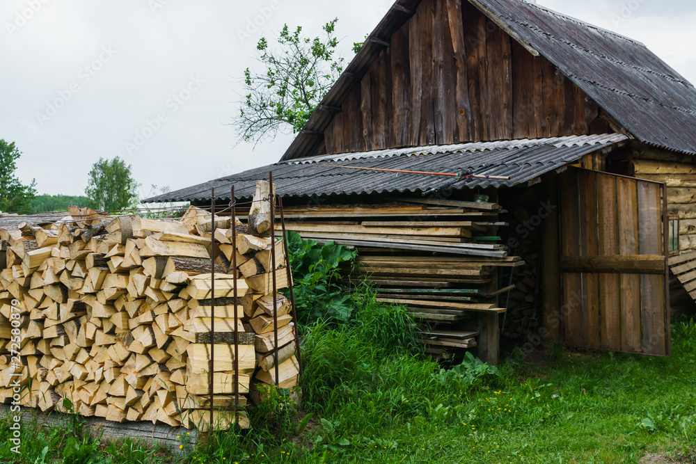 Fuel for stove heating at home and bath. Rural life. Wooden firewood is laid in the walls. Natural wood. Fuel for stove heating at home and bath. Rural life. Wooden firewood is laid in the walls. Natural wood.