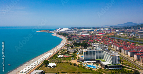 Aerial photography. Black sea coast. City the Russian resort of Sochi. Imereti lowland. Modern resort. Recreation area. Clear blue sky. Sunny day. Beach and sea. Hotels by the sea.