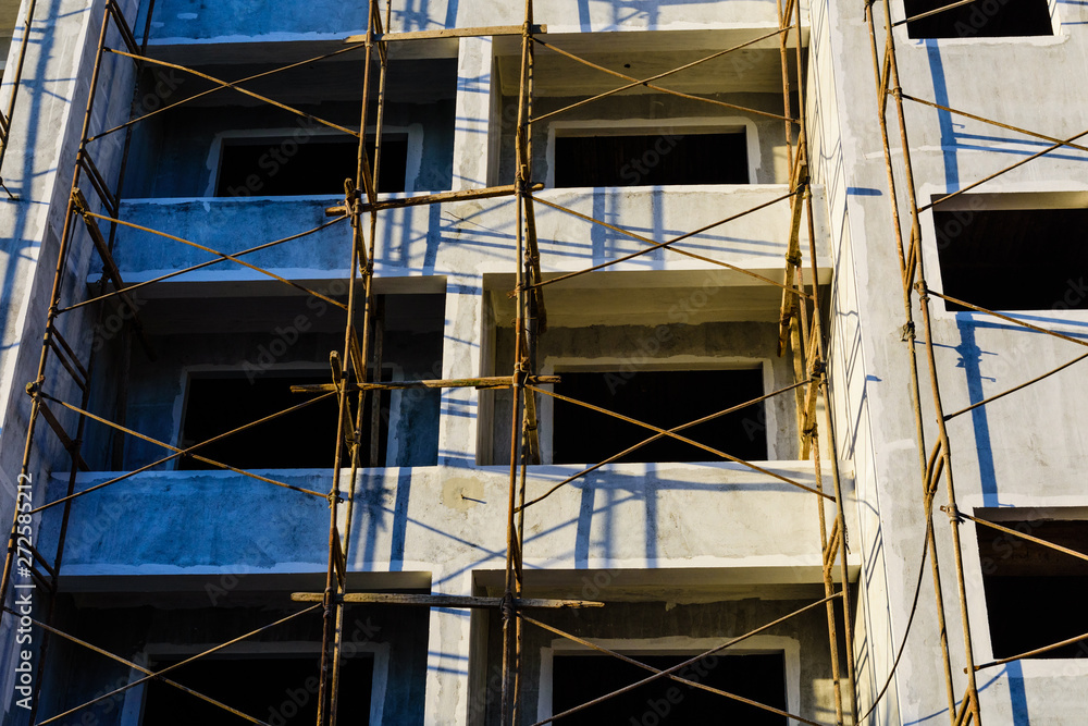 Construction of the new modern residential building in Hurghada, Egypt. Wooden scaffolding around the building