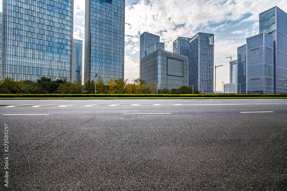 Panoramic skyline and modern business office buildings with empty road,empty concrete square floor Panoramic skyline and modern business office buildings with empty road,empty concrete square floor