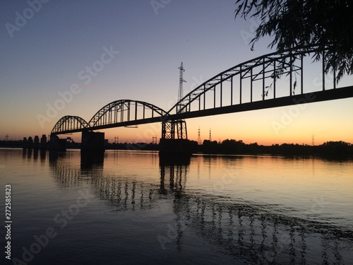 old military bridge over river at sunset