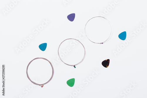 Flat lay steel guitar strings and plastic picks