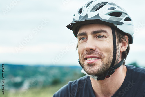 Attractive young man standing outdoors with protection helmet. Close up © Friends Stock