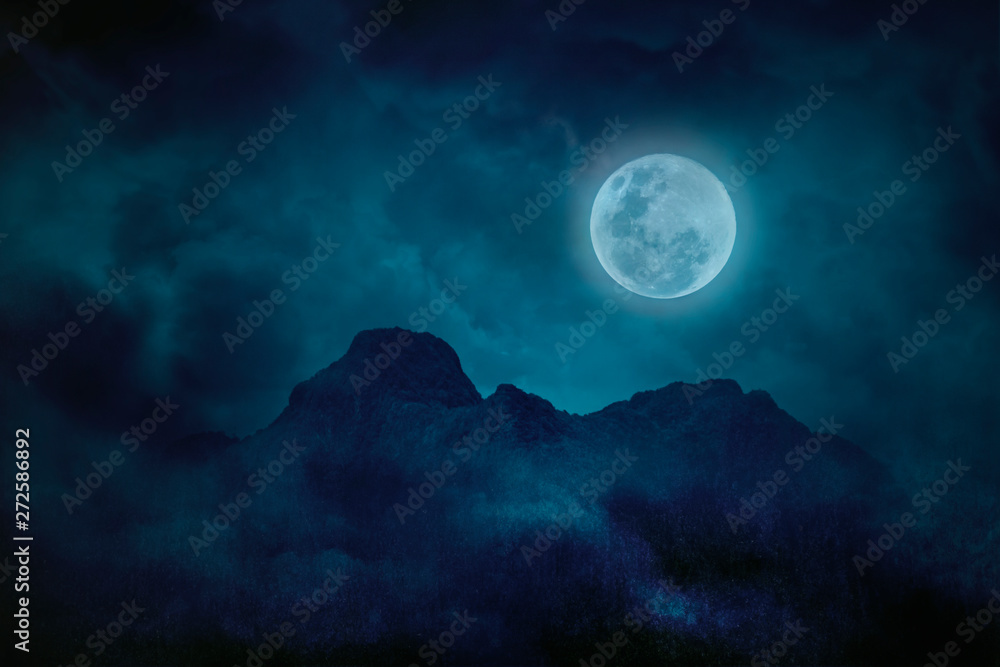 Blue full moon with mountains and forests in the darkness, Natural scary background Blue full moon with mountains and forests in the darkness, Natural scary background