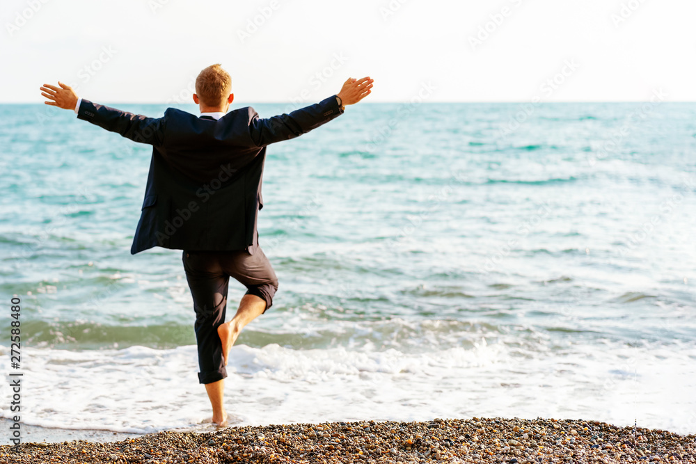Businessman doing yoga relaxation on the beach Businessman doing yoga relaxation on the beach