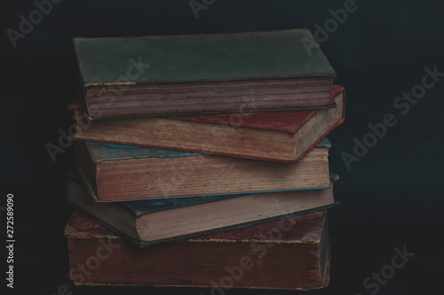 Old vintage books on dark background.