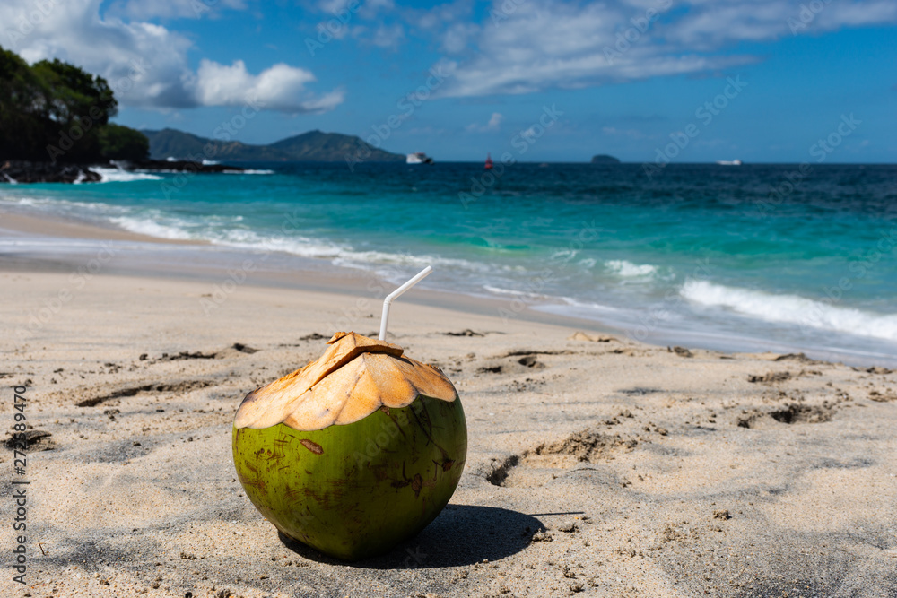 Fresh Coconut Cocktail the Beautiful Beach at Sunny Day Fresh Coconut Cocktail the Beautiful Beach at Sunny Day