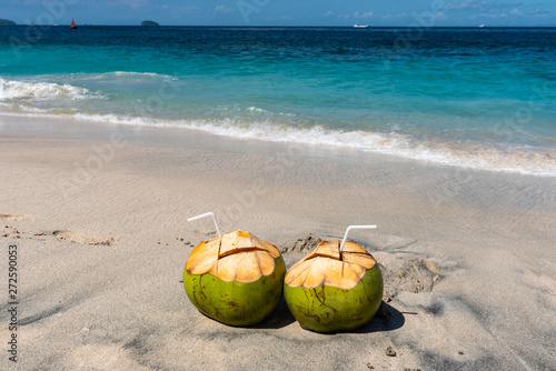 Two Fresh Coconut Cocktails on the Beautiful Beach at Sunny Day