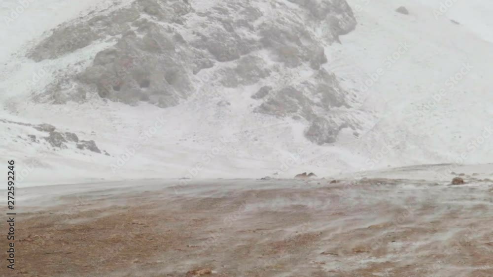 Driving over Song Kol Lake in the middle of winter with a blizzard and freezing conditions. Driving over a mountain pass with snow. Driving over Song Kol Lake in the middle of winter with a blizzard and freezing conditions. Driving over a mountain pass with snow.