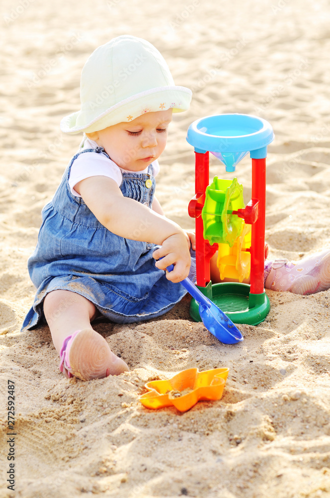 toddler girl playing toys in sand toddler girl playing toys in sand