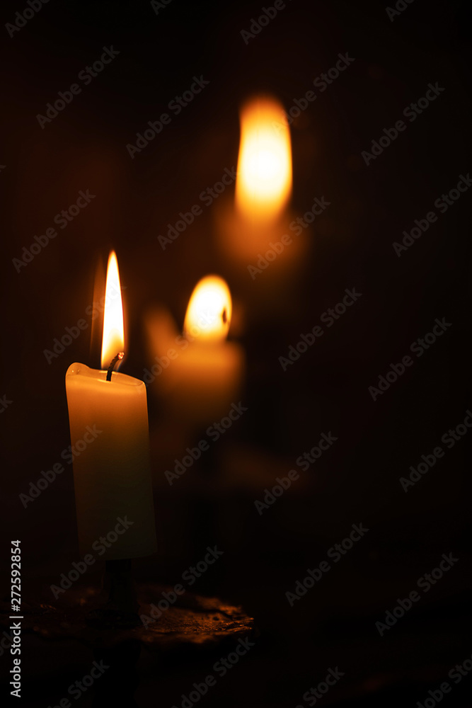 burning candles in church dark environment