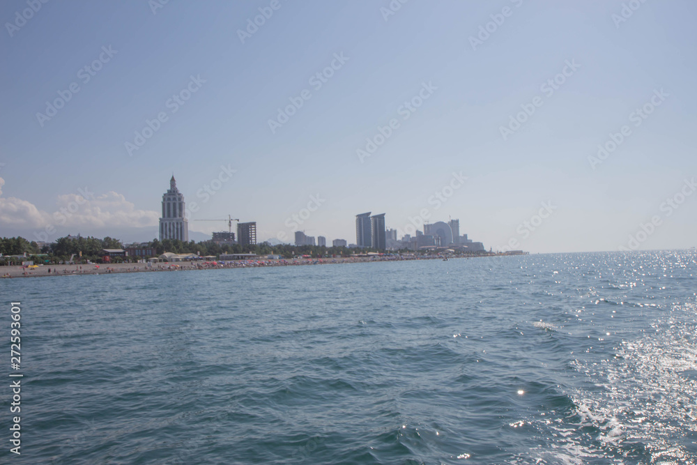 Georgia. Batumi Sea Port with boats. Moorage for boats. View From Sea of the embankment of the city from the sea