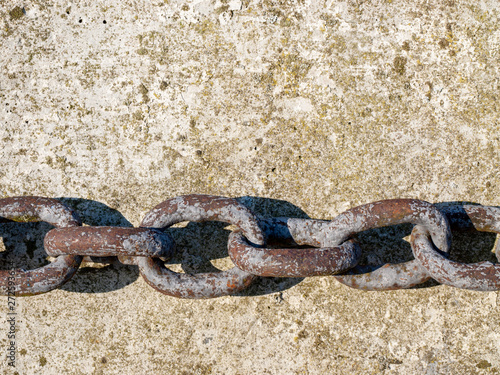 Iron chain on concrete pier.