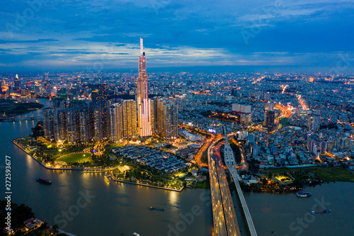 Top View of Building in a City - Aerial view Skyscrapers flying by drone of Ho Chi Mi City with development buildings  transportation  energy power infrastructure. include Landmark 81 and blue sky  