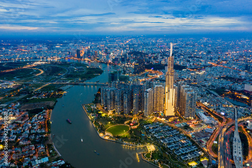 Top View of Building in a City - Aerial view Skyscrapers flying by drone of Ho Chi Mi City with development buildings, transportation, energy power infrastructure. include Landmark 81 and blue sky , © Nhut