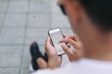 Man looking on navigation map. Travelers using gps map for sightseeing in town