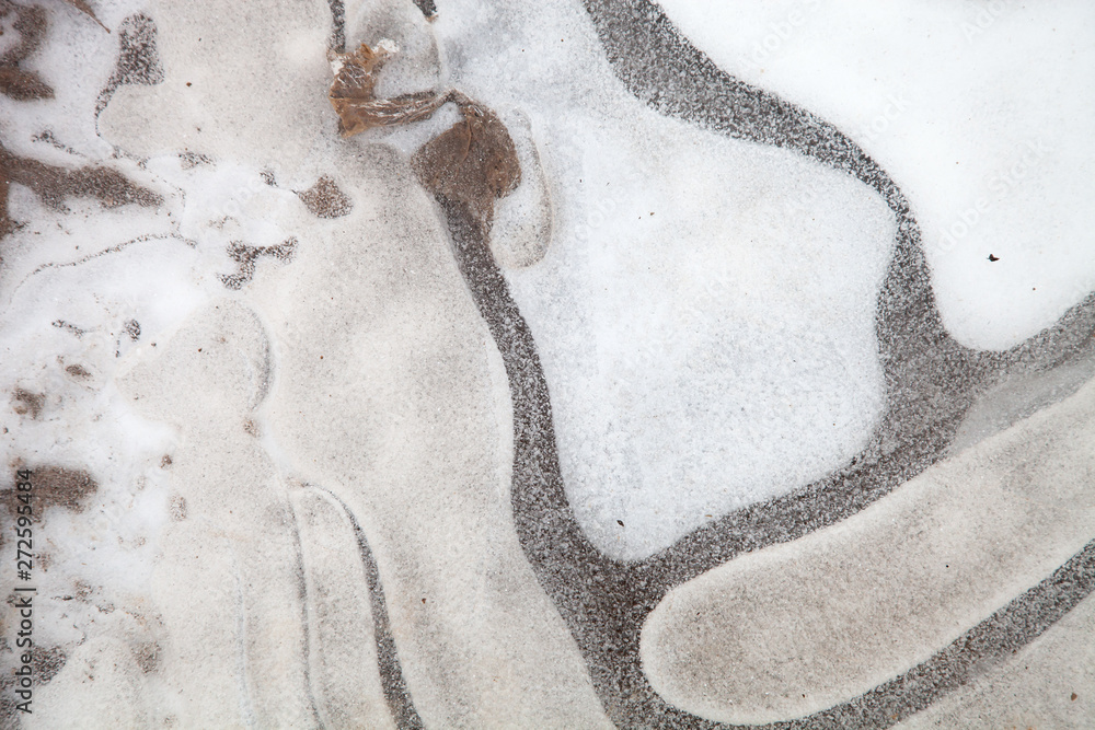 Abstract pattern of ice on the over of puddle