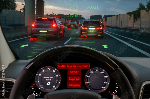 Obraz na płótnie view from the cockpit of a car equipped with HUD and active safety systems.The systems detected a traffic jam on the motorway and activated emergency braking w salonie