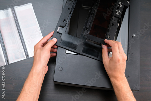 Wallpaper Mural Professional technician hand scanning negative film and slides, Torontodigital.ca