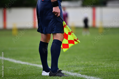 Assistant referee or Lineman of football or soccer holding flag