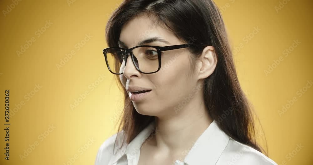 South asian woman in casual clothes looking somewhere, then getting positively surprised, looking at at camera, smiling and gesturing thumb up, isolated on yellow background close up 4k South asian woman in casual clothes looking somewhere, then getting positively surprised, looking at at camera, smiling and gesturing thumb up, isolated on yellow background close up 4k