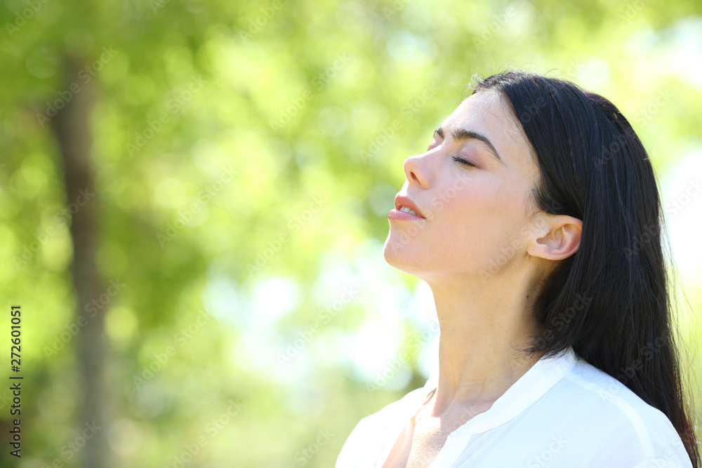 Beauty woman breathing fresh air in a forest Beauty woman breathing fresh air in a forest