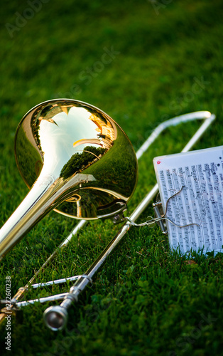 Photography A trombone lies on the grass before an open air concert
