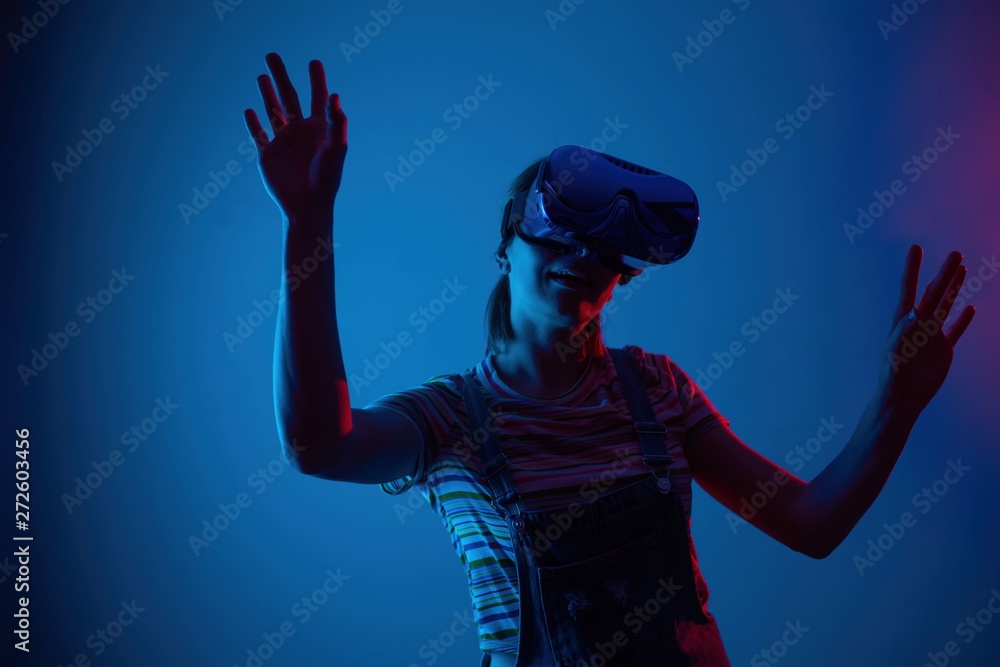 The game vr.The girl in the helmet and with the controller plays a game with creative light. The game vr.The girl in the helmet and with the controller plays a game with creative light.