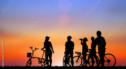 Silhouette group friend  and bike relaxing on blurry sunset background.
