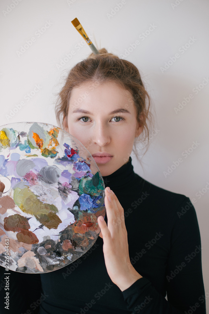 Fototapeta premium Woman painter with palette of paint in her hands