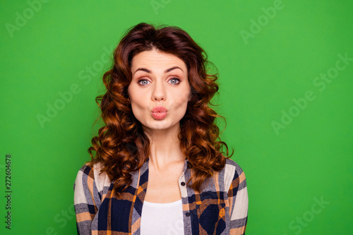 Close up photo of pretty lady send air kisses attract boy men boyfriend magnificent elegant makeup girlish feminine wear checkered modern outfit isolated on green background