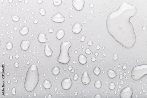 Drops of water on a color background. Gray