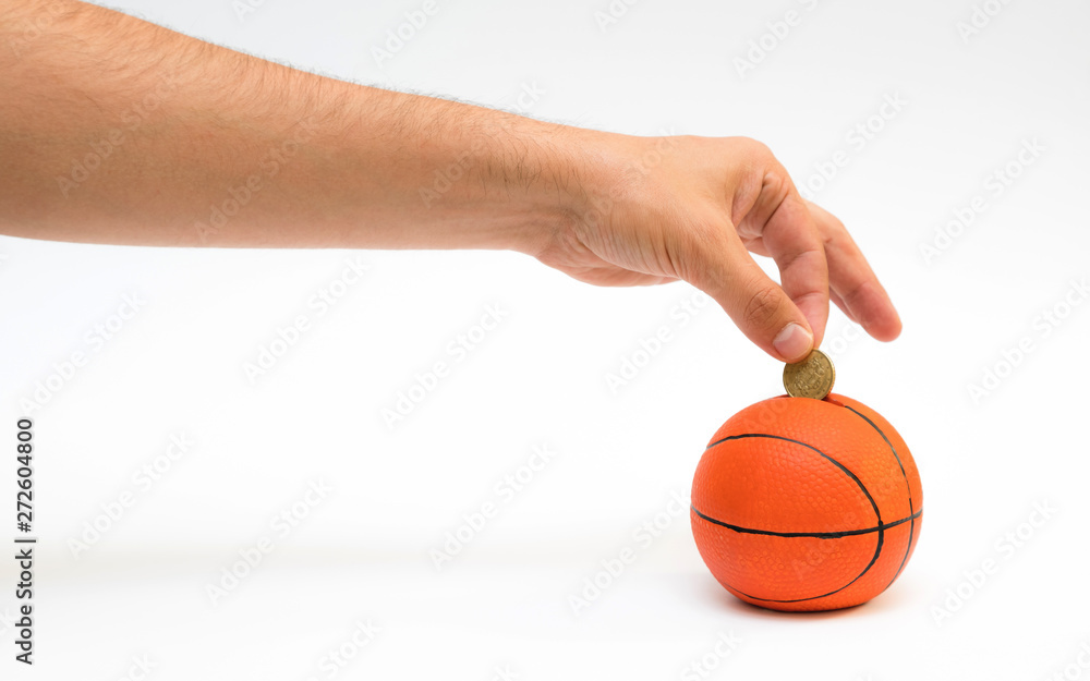 Male hand putting euro coin into the piggy bank with a shape of Male hand putting euro coin into the piggy bank with a shape of