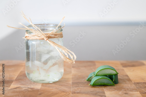 Essence from aloe vera plant in cosmetic bottle with slices of p