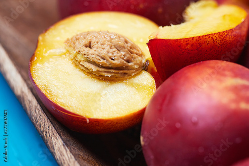 Fresh ripe nectarines on blue rustic wooden background