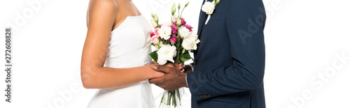panoramic shot of african american bride and bridegroom holding bouquet isolated on white