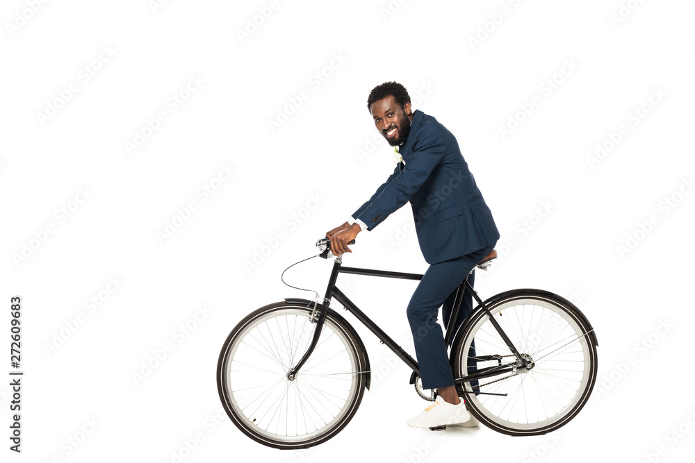 happy african american bridegroom riding bicycle isolated on white happy african american bridegroom riding bicycle isolated on white