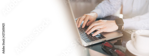 Cropped image of a young man working on his laptop  man hands busy using laptop at office desk. Young businessman working with laptop at office. Copy space