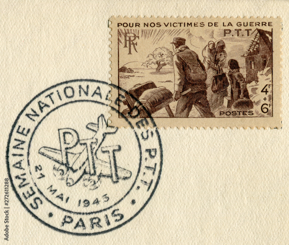 Paris, Republic of France - 21 May 1945: French historical stamp: For our war victims. The family leaves their ruined home, special postal cancellation, second world war