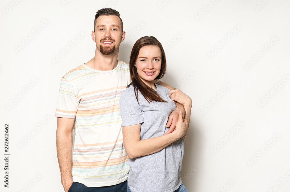Happy young couple on light background Happy young couple on light background