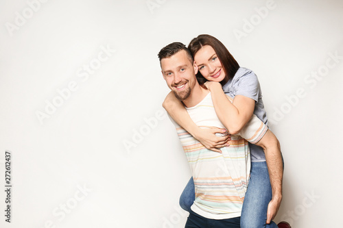Happy young couple on light background