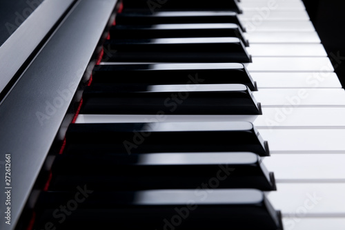 Grand piano keyboard with glossy black and white keys as a music  Select focus and soft focus.