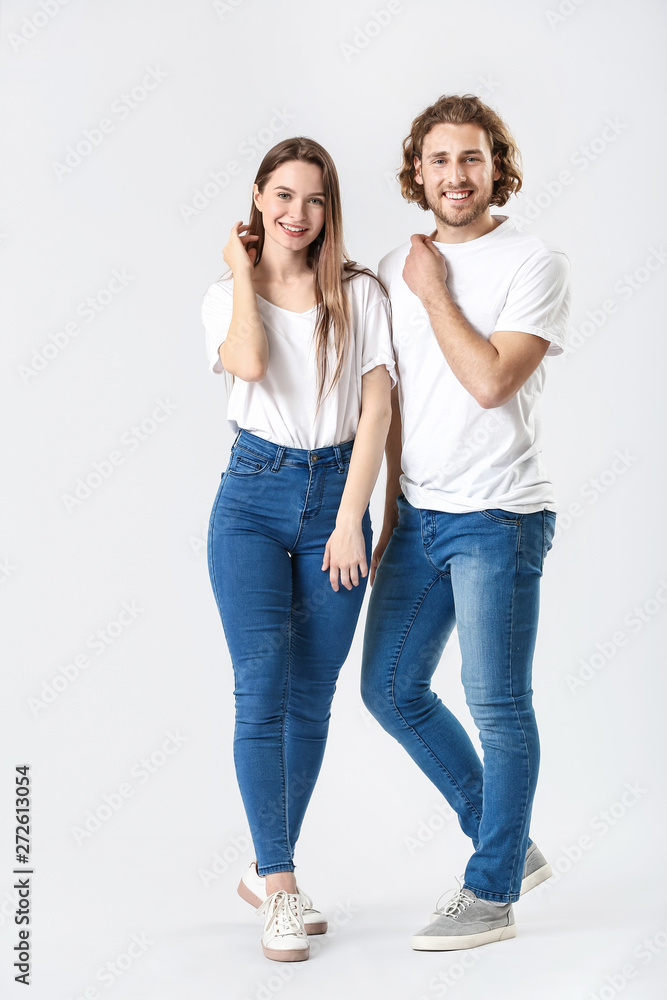 Stylish young couple in jeans on white background Stylish young couple in jeans on white background